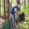 A man throws old leaves in the garden