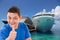 Man with thumbs up in front of two cruise ships