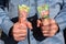 Man tightly holding Canadian twenty and fifty dollar bills in both hands