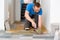 Man tiling floor using trowel