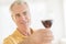 Man Toasting Red Wineglass At Home