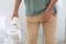 Man with toilet paper suffering from hemorrhoid in rest room