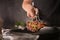 Man with tongs cooking tasty meat in kitchen