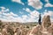 A man at the top of a hill in Cappadocia in Turkey looks up to the amazing clouds. Travel, success, freedom, achievement