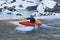 Man On Top of Ice Flow In Orange Kayak