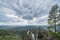 A man on top of a mountain in Siberia, spread his hands up. beautiful landscape, sky and river. stunning view from the top