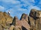 Man on top of a rocky mountain cliff