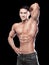 Man with torso, muscular macho with six packs, dark background. Man smiley face with muscular figure, sportsman