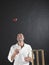 Man Tossing Cricket Ball By Stumps In Air