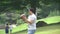 Man tossing a football in a hilly park