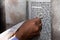 Man touches the text of a Torah scroll with his tzitzit