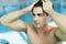 Man touching his hair in the swimming pool