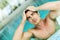 Man touching his hair in the swimming pool