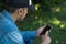 Man touching his mobile and listening to music with wireless earbuds. Close up. Technological concept