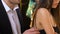 Man touching upset girlfriend shoulder at party, lady unwilling to talk, offence