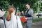 man is a tour guide inviting a group of tourists on a tour.