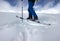 Man with touring ski climbing mountain in fresh snow