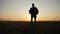 Man tourist with backpack silhouette travel goes on an adventure. sunset time sunlight. slow motion video hiker walks