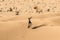 Man tourist in desert rub al khali Oman throwing sand 3