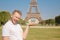 Man tourist Eiffel tower making selfie and smiling. Beautiful European guy enjoying vacation in Paris, France. Concept
