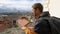 Man tourist enjoying breathtaking cityscape, male looking on the city roofs