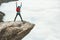 Man tourist jumping on Trolltunga rocky cliff mountains