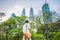 Man tourist in Malaysia looks at the Petronas Twin Towers