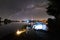 Man tourist resting sitting on chair on lake shore at night