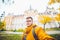 Man tourist taking selfi in front of castle