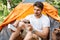 Man tourist using cell phone and portable mini speaker