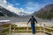 A  man tourist is watching Panorama view the mueller glacier and mueller lake at kea point in Mount Cook