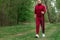 A man in a tracksuit is engaged in Nordic walking. The concept of a healthy lifestyle, cardio training. Copyspace