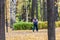 A man in a tracksuit walks quickly through the autumn park