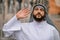 A man in traditional arabian clothing waving his hand