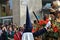 Man in a traditional costume covering his face beats a bell during the traditional Easter procession of SemanÐ° Santa