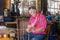 Man in traditional Dutch costume mending fishing nets in workshop