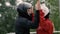 Man trainer instructing woman skydiver before flight into wind tunnel