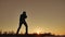 Man is training doing an imitation boxing lifestyle shadow fight. Martial arts concept. Silhouette man on a hill nature