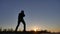 Man is training doing an imitation boxing shadow fight lifestyle. martial arts concept. silhouette man on a hill nature