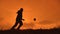 Man is training freestyle bal Hacky On Sunset Sack silhouette freestyle concept lifestyle . man playing soccer stuffing
