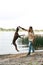 Man training jumping Kurzhaar dog catching stick