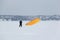 Man training with a kite on a frozen river in winter, Kama Reservoir, Perm city, Russia