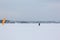 Man training with a kite on a frozen river in winter, Kama Reservoir, Perm city, Russia