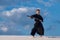 Man is training martial arts in desert