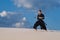 Man training martial arts, iaido, in desert