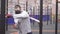 Man in a training mask on his face boxing on a sports street playground,slow mo