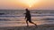 Man training Tai Chi chuan while evening sunset at sea shore