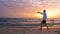 Man training Tai Chi chuan while morning sunrise in sky at sea beach
