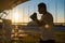 A man trains in boxing at the stadium at sunset. Athlete silhouette.