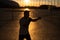 A man trains in boxing at the stadium at sunset. Athlete silhouette.